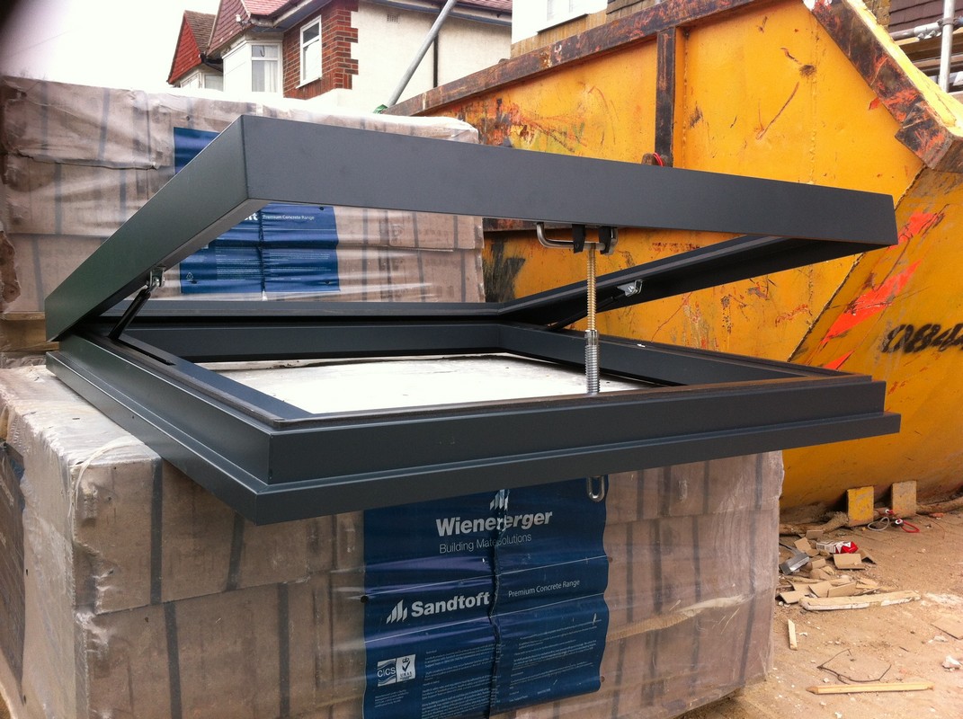 Opening flat roof skylight in anthracite grey installed in Ealing