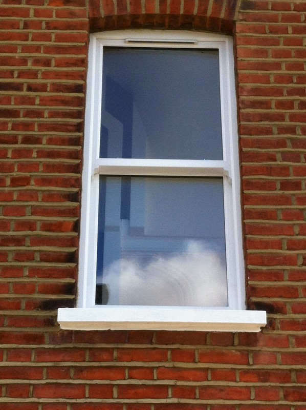uPVC sash window on Victorian red brick house in Ealing